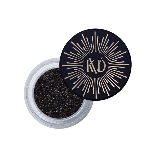 Open tub of KVD Dazzle Flakes eye pigment in shade Polar Night.