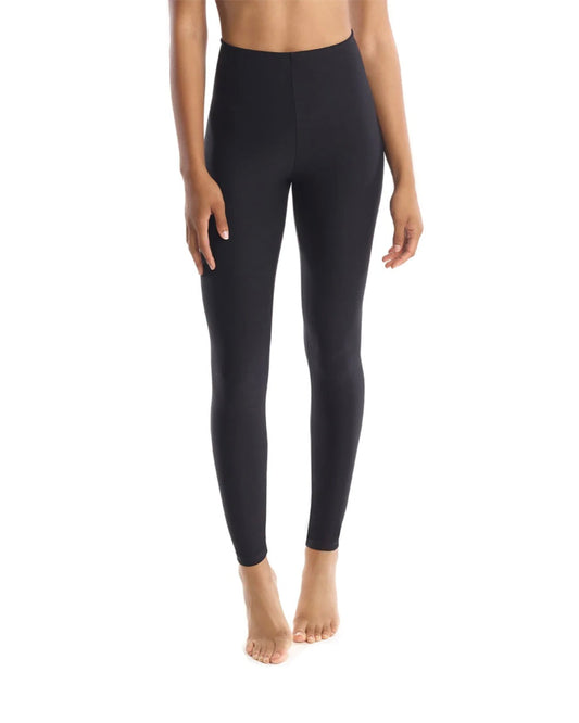 Model wearing commando perfect control black leggings no shirt on a white background